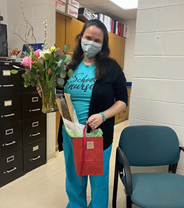 School nurse holding flowers